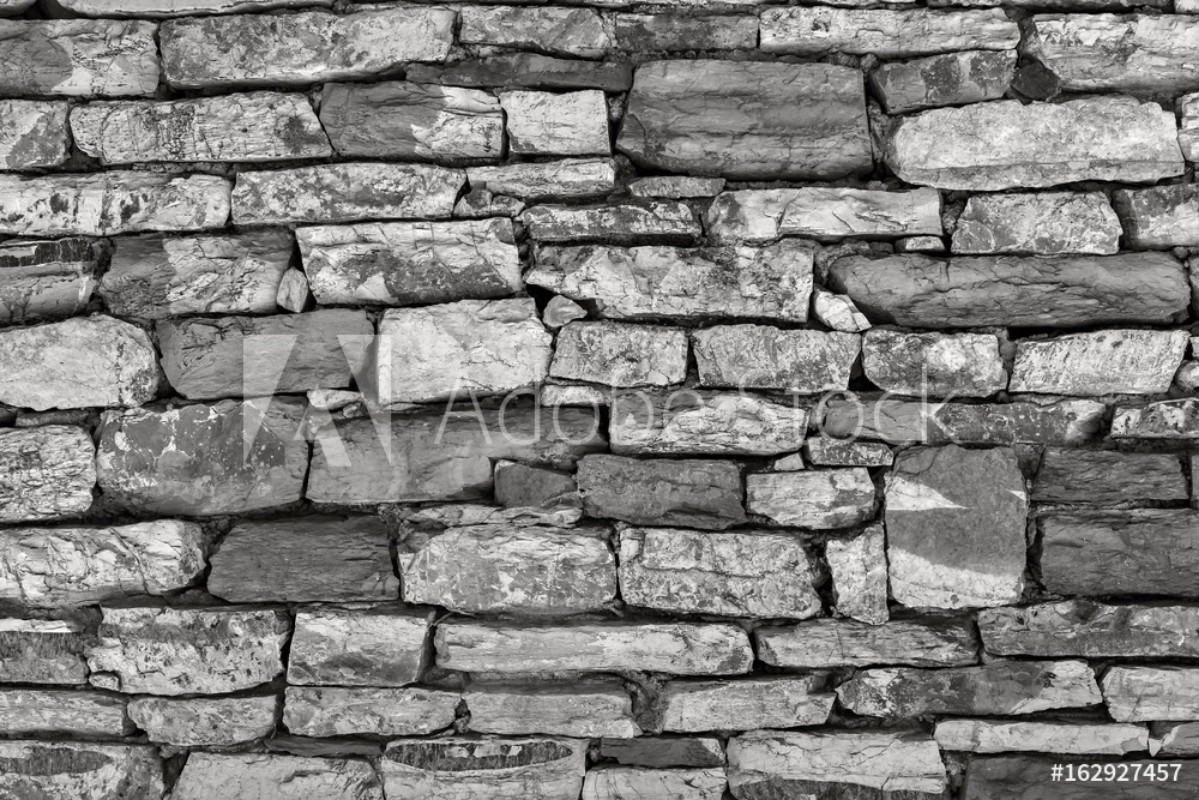 Picture of fragment of a stone wall of monochrome tone